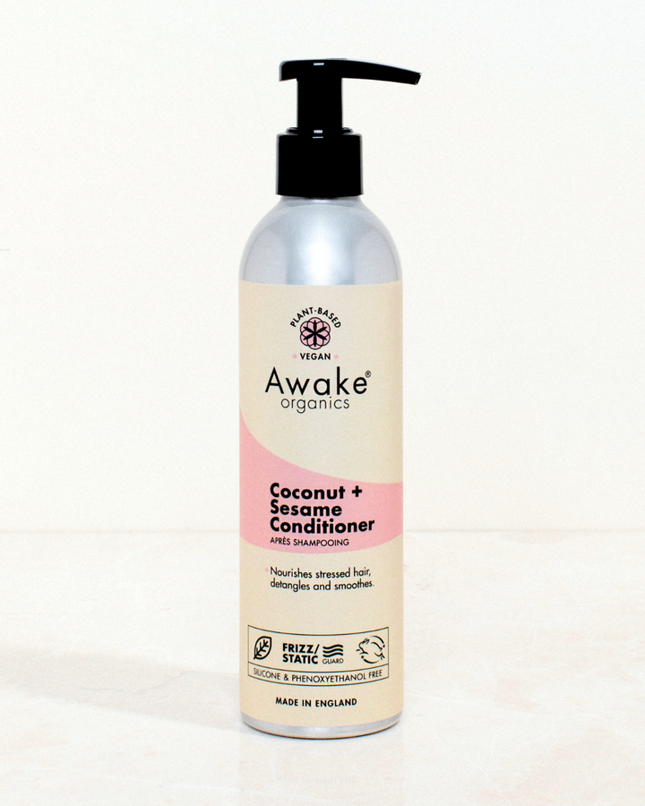 Awake Organics Coconut and Sesame Hair Conditioner with pump dispenser on a neutral background