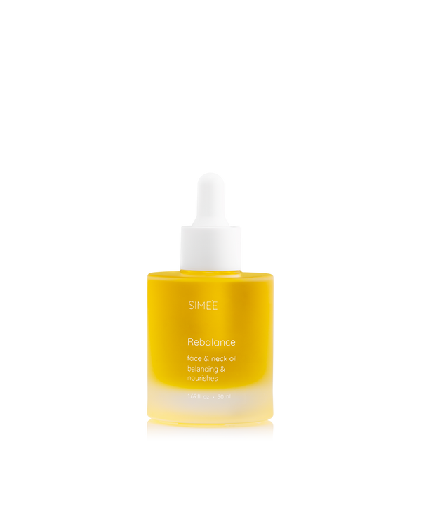 Clear dropper bottle of SIMÉE Rebalance face oil isolated on a black background